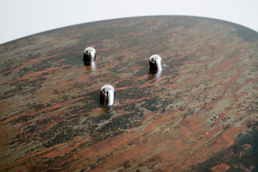 Detail of the "Time table", polished Stainless steel legs with patinated steel tabletop. Created by Kevin Oyen, designer and artisan metalworker